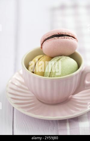 Colourful macarons in a rosy cup Stock Photo