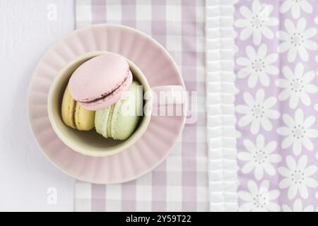 Colourful macarons in a rosy cup Stock Photo