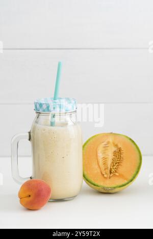 Healthy orange smoothie with yogurt, melon and apricot in a glass Stock Photo