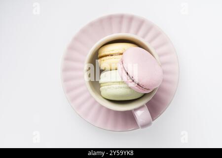 Colourful macarons in a rosy cup Stock Photo