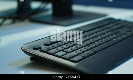 Extreme close up shot of computer displays on desk in server farm used for overseeing equipment. Monitors in data center facility with networking systems installed used for managing rigs Stock Photo