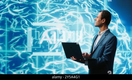 IT expert solving tasks on laptop device, running artificial intelligence programming scripts. Indian man using notebook to write lines of code for AI applications development, camera A Stock Photo