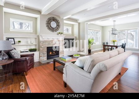Sunny living room with white woodwork and view into dining room Stock Photo