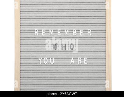 Letter board with phrase Remember who you are on white background, top view Stock Photo