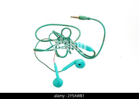 A pair of turquoise earbuds, crumpled, worn and broken, lying on a white background Stock Photo