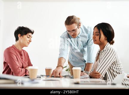 Creative, talking or interior designers in meeting for planning, discussion or brainstorming in brand strategy. Books, group or people in startup for Stock Photo