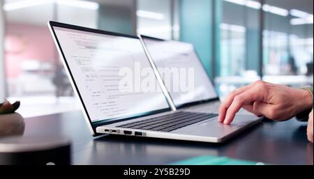 Coder Using Computer At Desk. Web Developer Stock Photo