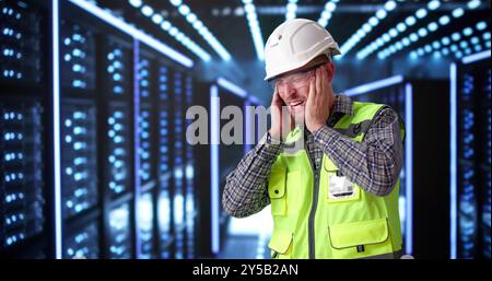 Engineer Suffering From Loud Noise In Data Center Server Room Stock Photo