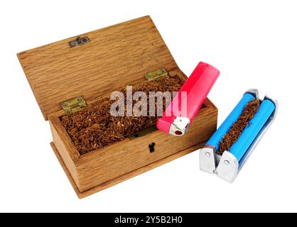 Hand rolling cigarette items including a wooden box of shredded rolling tobacco, cigarette roller machine and disposable gas lighter isolated on a whi Stock Photo