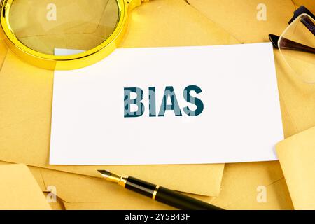 Business bias concept. BIAS on the card against the background of scattered envelopes Stock Photo