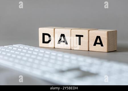 Data concept. The word DATA written on wooden cubes on a computer keyboard background. Data storage concept Stock Photo