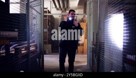Male Security Guard Or Bodyguard Using Flashlight At Night Stock Photo