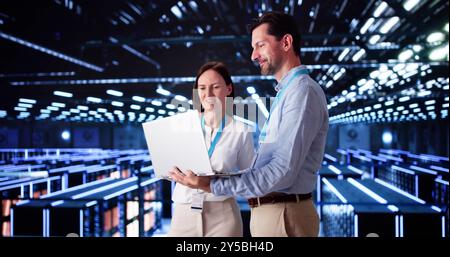 Server Room In Data Center. Cloud Computer Engineers Configuring AI Technology Stock Photo