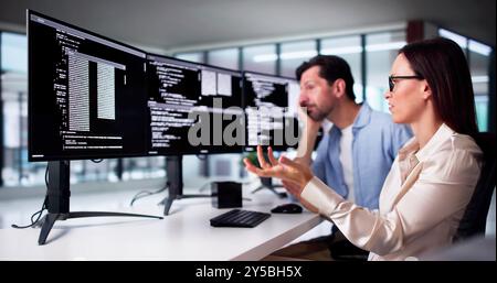 Unhappy Sad Developer Programmers In Stress Coding Software On Computer Stock Photo