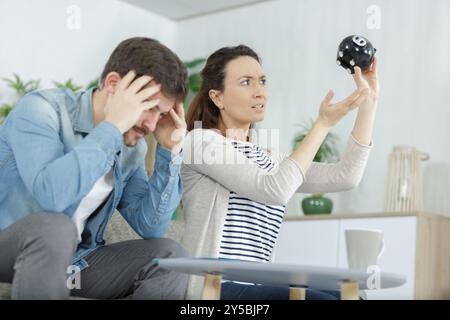 young couple holding piggy bank with no money Stock Photo