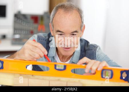 man working and checking level with contour Stock Photo