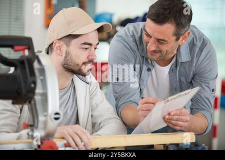 student and teacher in carpentry class Stock Photo
