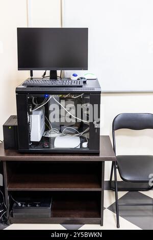 wooden pedestal in office with server, router, computer monitor, uninterruptible power supply Stock Photo
