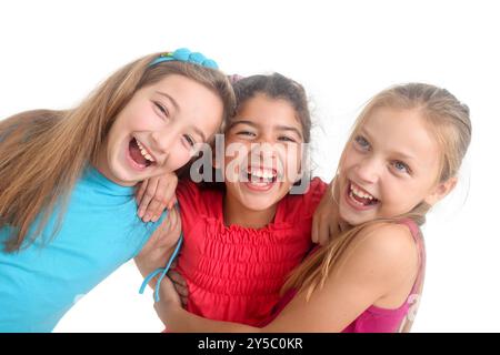 multiethnic group of cheerful preteen girls having fun on isolated white background Stock Photo