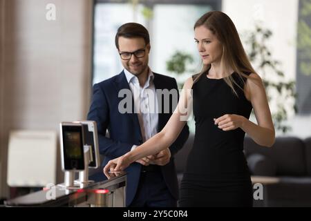 Millennial couple of business colleagues walking through office center gate Stock Photo