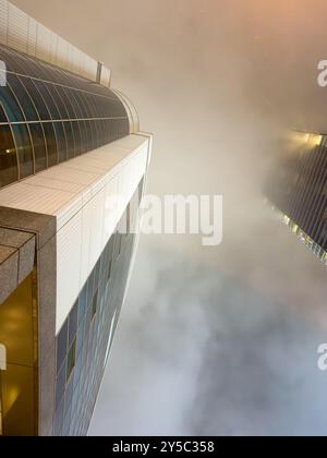 Skyscrapers under view. Japan. High rise office buildings top hidden on cloudy sky background Stock Photo