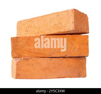 Side view of old red or orange bricks in stack is isolated on white background with clipping path. Stock Photo