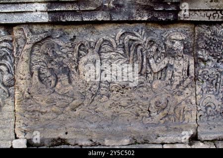 relief or carving on the stone wall at Penataran temple Stock Photo