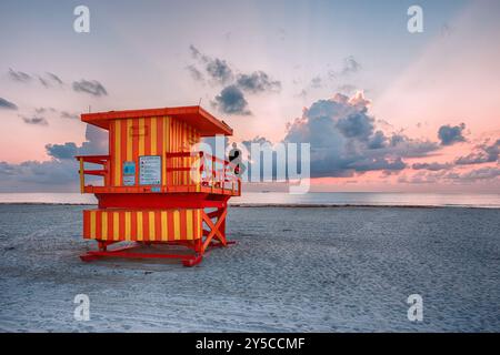 3rd Street Lifeguard Tower at Dawn Overlooking the Serene Miami Beach With Vibrant Art Deco Architecture and a Colorful Sky Stock Photo