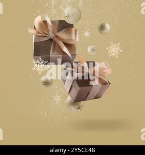 Gift boxes, Christmas balls and decorative snowflakes in air on dark beige background Stock Photo