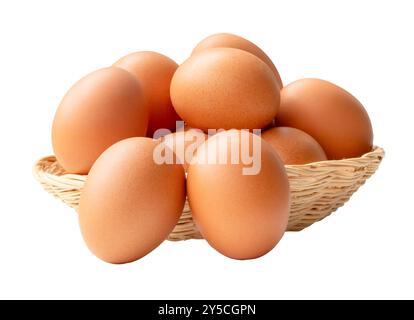 Group of fresh brown chicken eggs in stack in wicker basket is isolated on white background with clipping path. Stock Photo