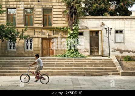 Boy on bicyle baku azerbaijan Stock Photo