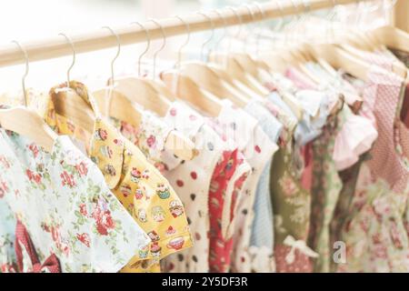 Floral pattern young girl dresses in children wear fashion shop Stock Photo