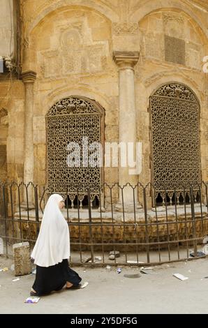 Street scene with veiled woman in cairo old town egypt Stock Photo