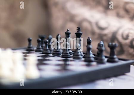A classic chess board displaying an array of black and white pieces strategically placed upon it, inviting a challenging game of intellect Stock Photo