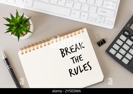 break the rule written in a notebook lying on a desk at work. Business concept. flat lay. Stock Photo