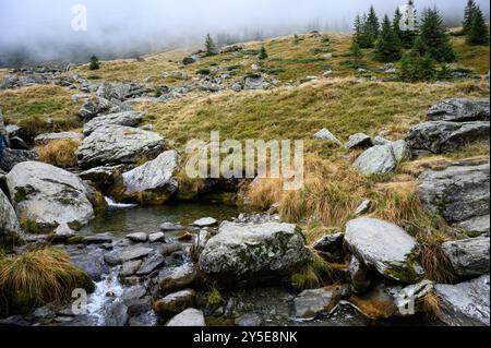 Foggy river scenery on the Transfagarasan road route on an autumn day, Romania Stock Photo