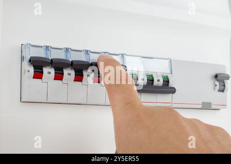 Hand Switching Off Electrical Circuit Breaker Stock Photo