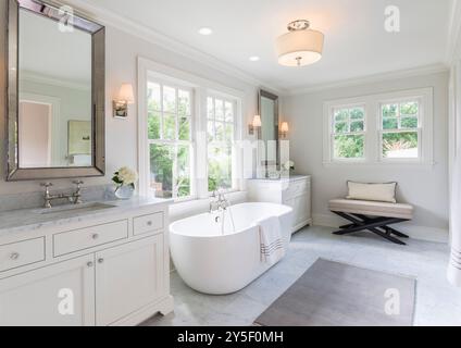 High end white master bathroom with large soaking tub Stock Photo