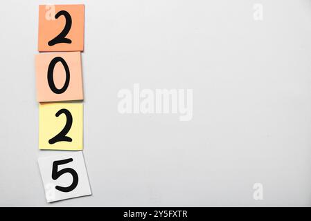 New year's resolutions 2025 on the sticky note isolated gray background. New year concept with typographic 2025. Motivational words for the new year 2 Stock Photo