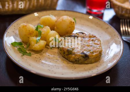 Chicken cutlet with vegetables with boiled potatoes on a plate Stock Photo