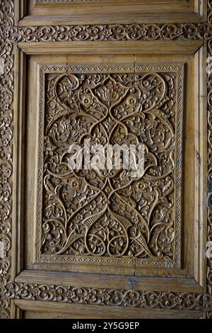 Detail of a carved wooden door entrance to a madrassa at the Registan in Samarkand Stock Photo