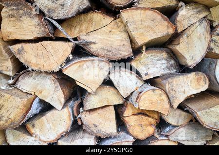 Textured firewood background of chopped wood for kindling and heating the house. Woodpile with stacked firewood. Texture of birch tree Stock Photo