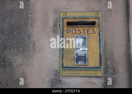 A yellow LA POSTE post box embedded in a wall in Cotignac, Var, South of France, French postal services Stock Photo
