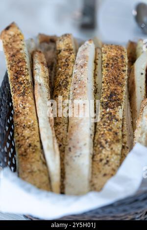 Close-Up of Bread Sticks with Sesame Seeds in a Basket Stock Photo