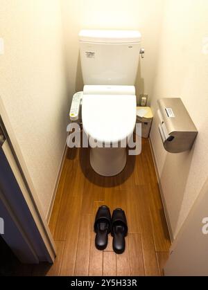 A traditional Japanese hotel bathroom with provided slippers in Yuzawa, Japan Stock Photo