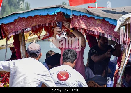 Srinagar, India. 22nd Sep, 2024. Former chief minister of Jammu and Kashmir and the leader of Jammu and Kashmir National Conference (JKNC) Omar Abdullah, takes pictures during an election boat rally at Dal Lake in Srinagar. National Conference (NC) held an election boat rally across the world famous Dal Lake, ahead of the second phase of Assembly polls. Credit: SOPA Images Limited/Alamy Live News Stock Photo