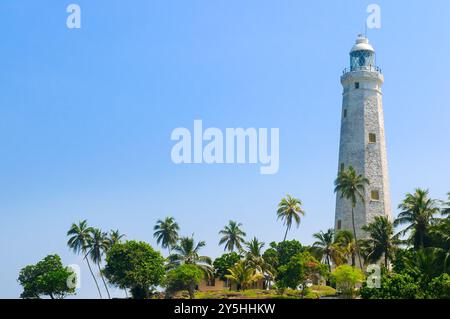 Beautiful white lighthouse Dondra Head, the southernmost cape of Sri Lanka - seen from the beach. The lighthouse is also a highest (161 feet) not only Stock Photo