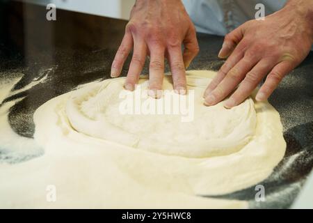 Making a pizza, close up of hands kneading the pizza dough Stock Photo