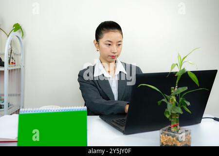 Attractive Asian Chinese Female Young Manager in Formal Dress in Office Gives Gestures Wow Happy with Calendar Mockup Stock Photo