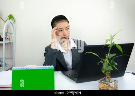 Attractive Asian Chinese Female Young Manager in Formal Dress in Office Gives Gestures Wow Happy with Calendar Mockup Stock Photo